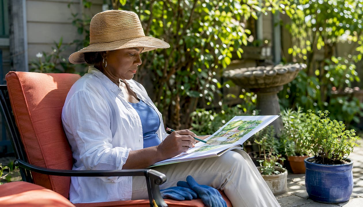 Homeowner reviewing landscape plans outdoors