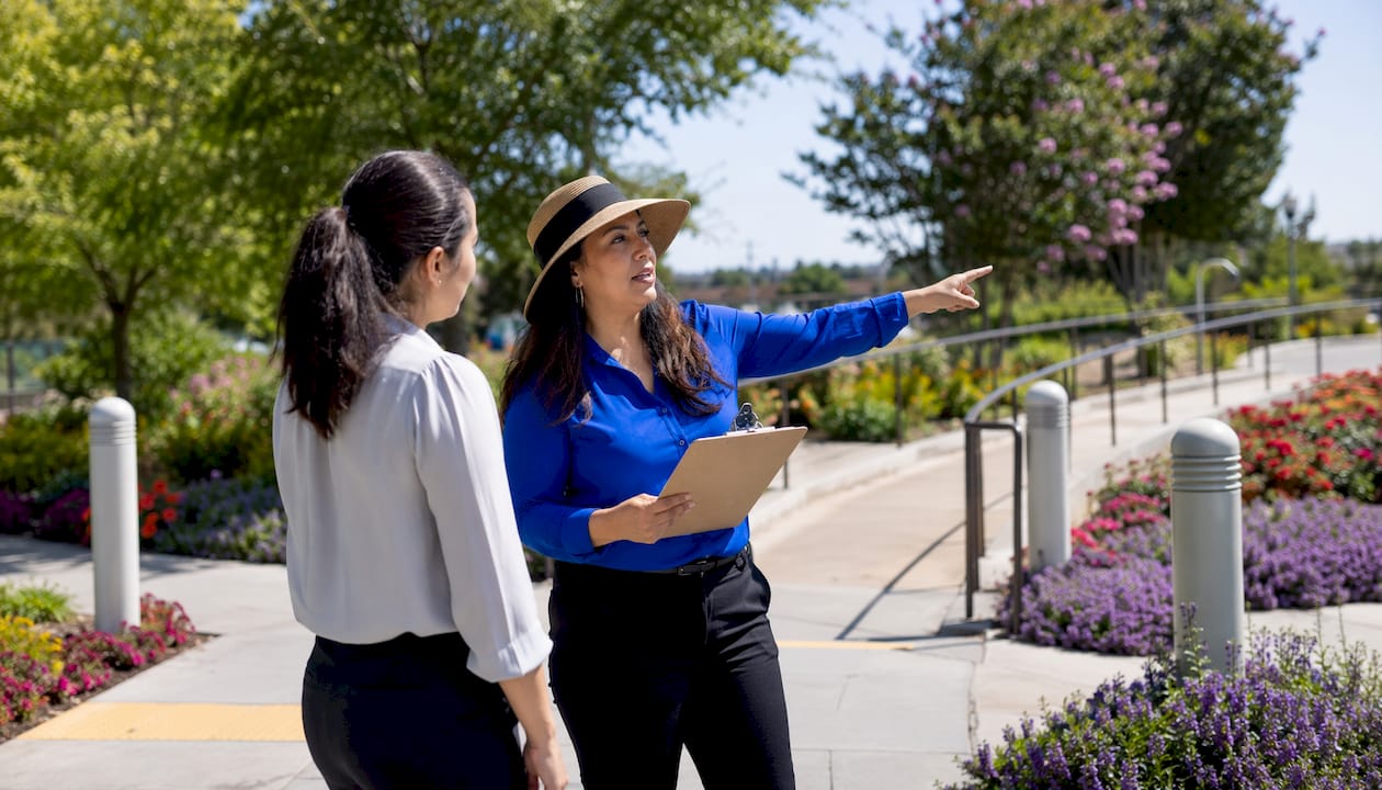 Property owner reviewing ADA compliant landscaping pathway