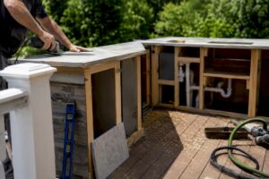 Installation of outdoor kitchen countertop on deck