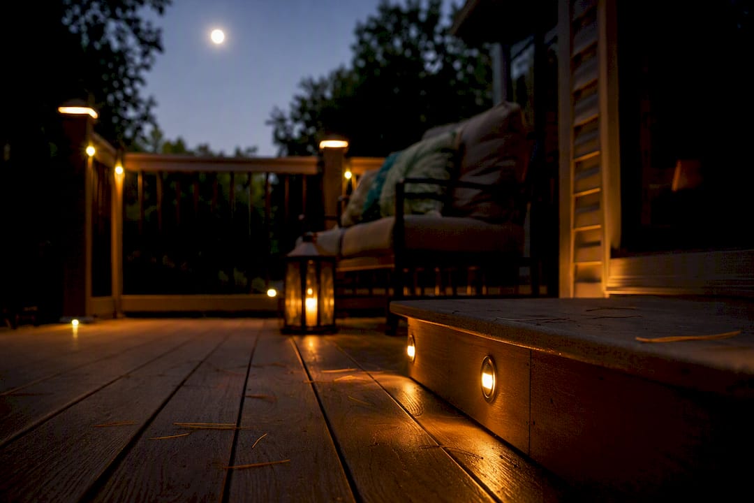 Nighttime deck with warm outdoor lighting