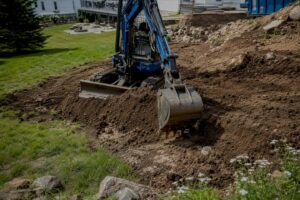 Bobcat loader grading residential yard soil