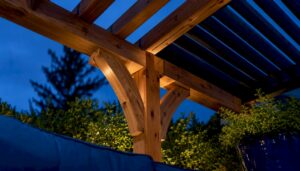 Cedar pergola beams above a landscaped terrace