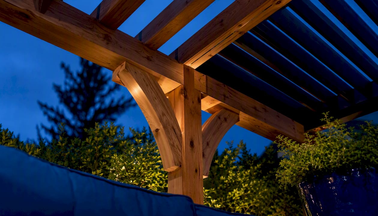 Cedar pergola beams above a landscaped terrace