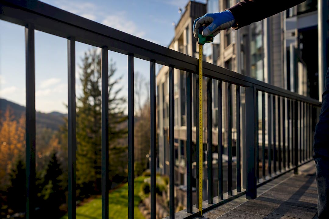 Tape measure checking outdoor guardrail height