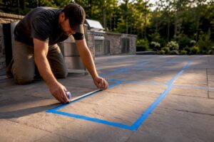 Full-scale tape layout on outdoor kitchen patio