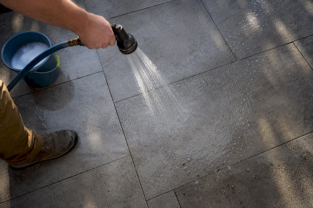 Garden hose rinsing porcelain paver joints