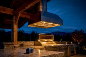 Covered outdoor kitchen with ventilation hood