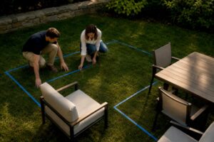 Patio furniture arranged within taped layout