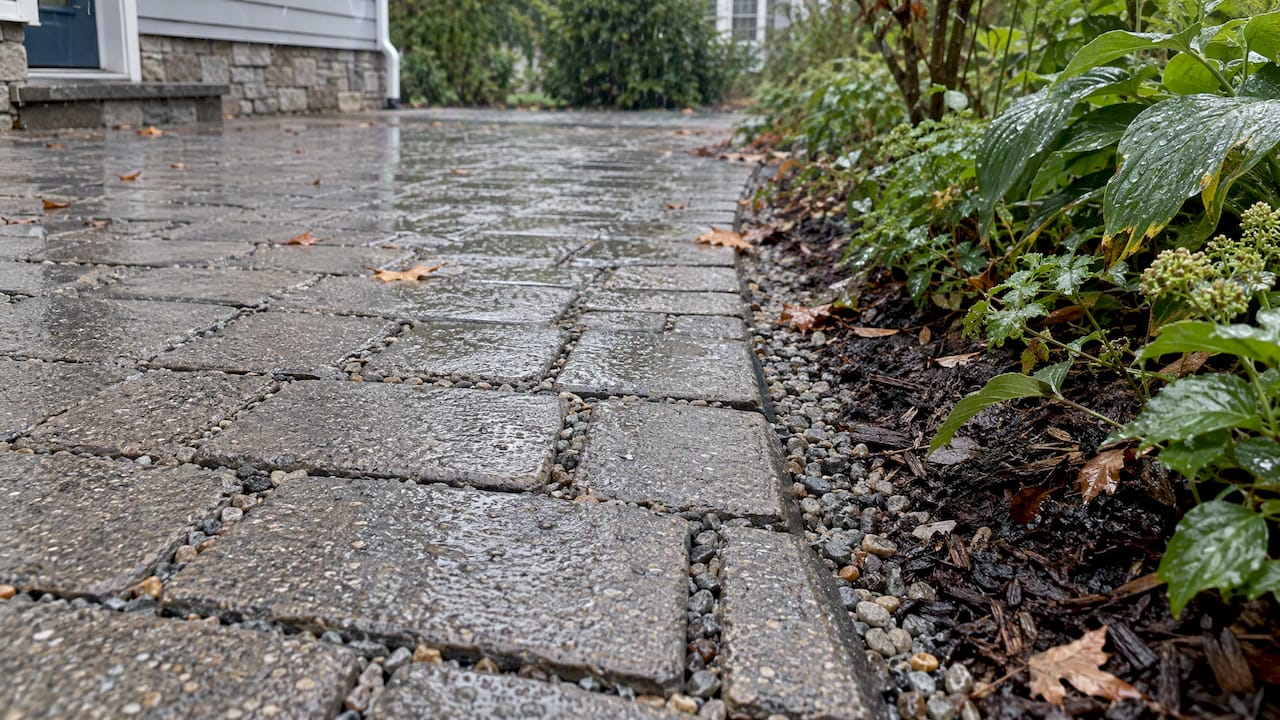 Permeable pavers absorbing rainwater through open joints
